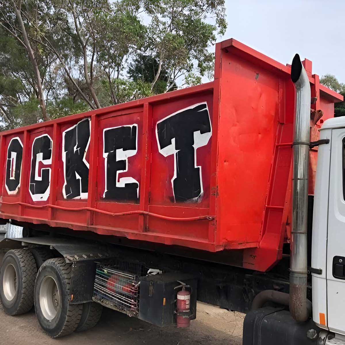Close-up of the red bin painted with ROCKET on the hook-lift truck