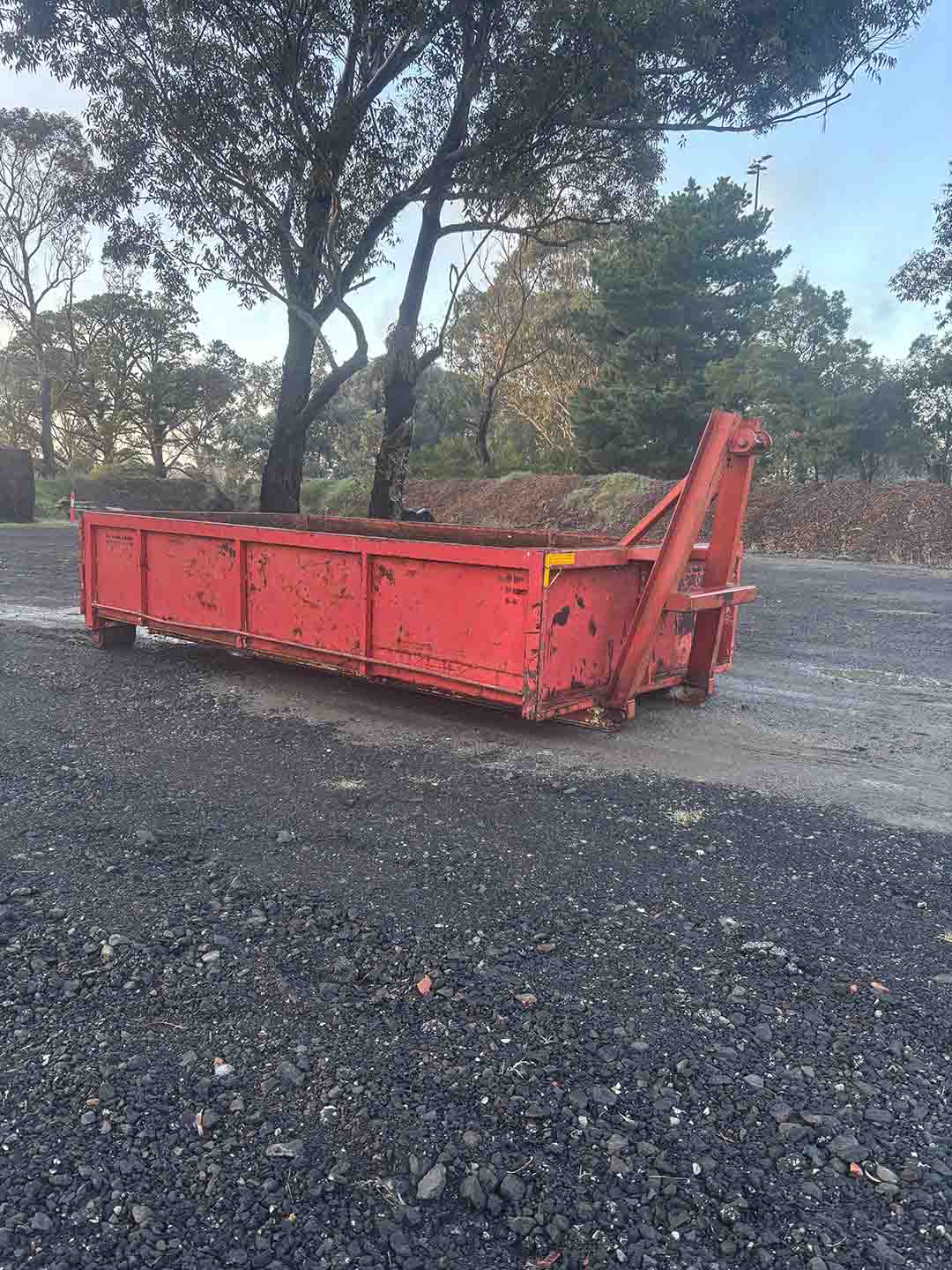 s3a Red 10m³ walk-in bin on a gravel yard under gum trees